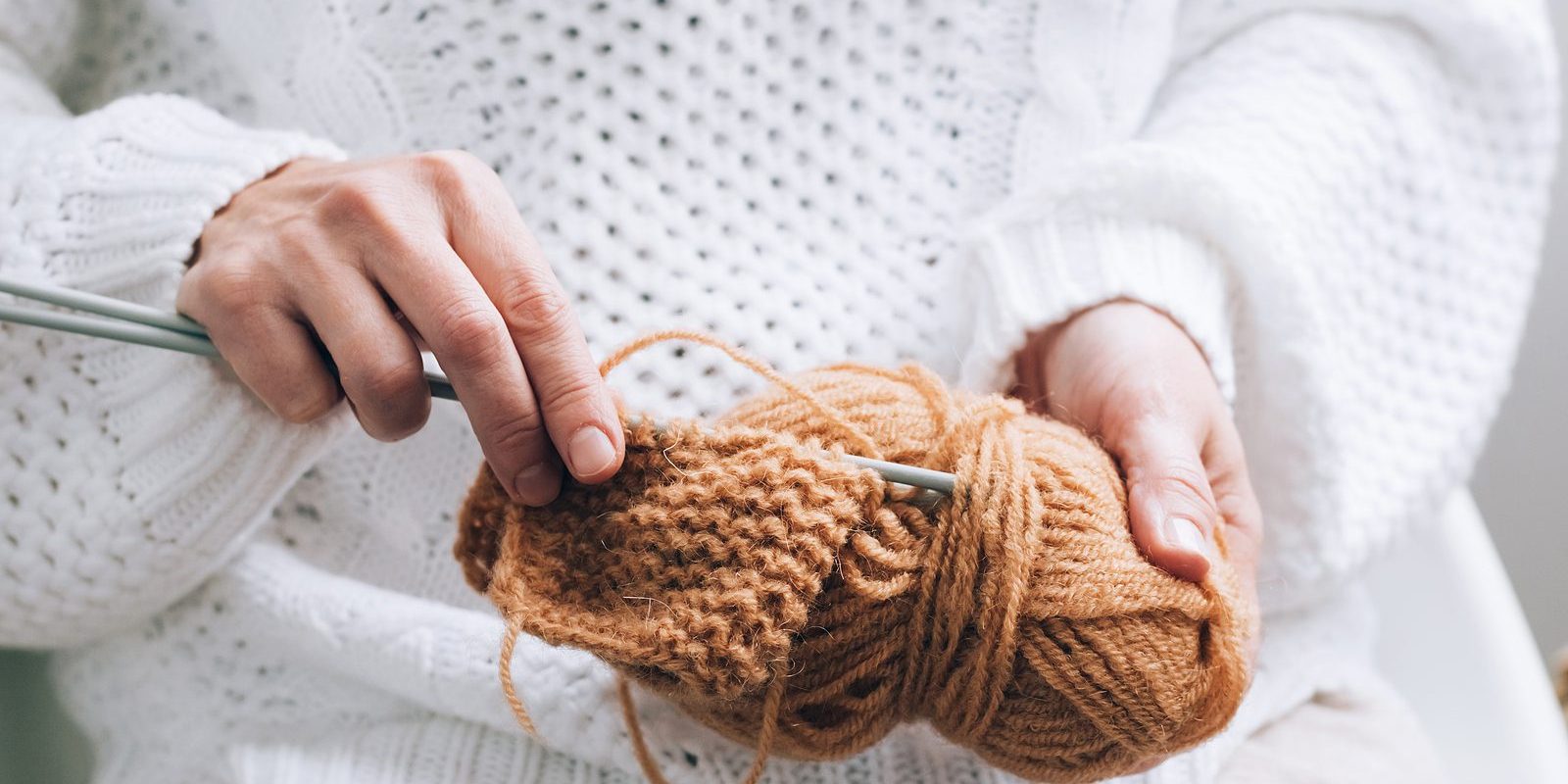 Womens Hands Are Engaged In Knitting Needlework. Threads For Kni