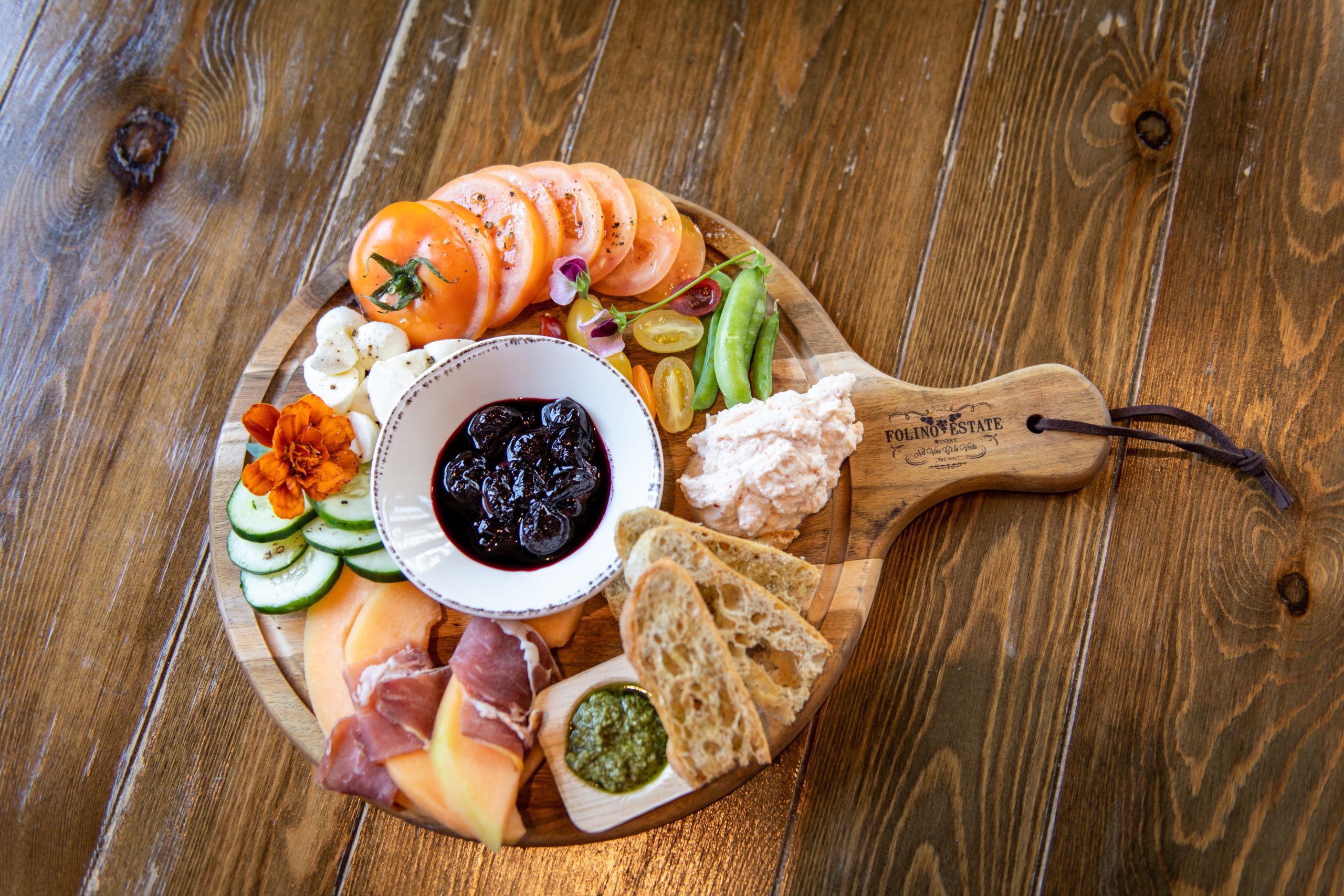 Wooden charcuterie board with meats and vegetables