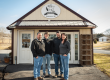 Kamp family posing in front of the ACEC Farm & Market.