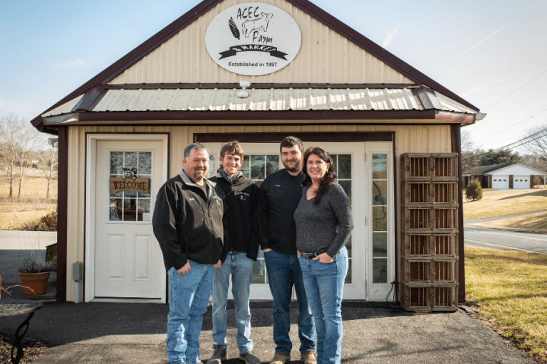 Kamp family posing in front of the ACEC Farm & Market.