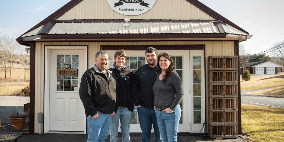 Kamp family posing in front of the ACEC Farm & Market.